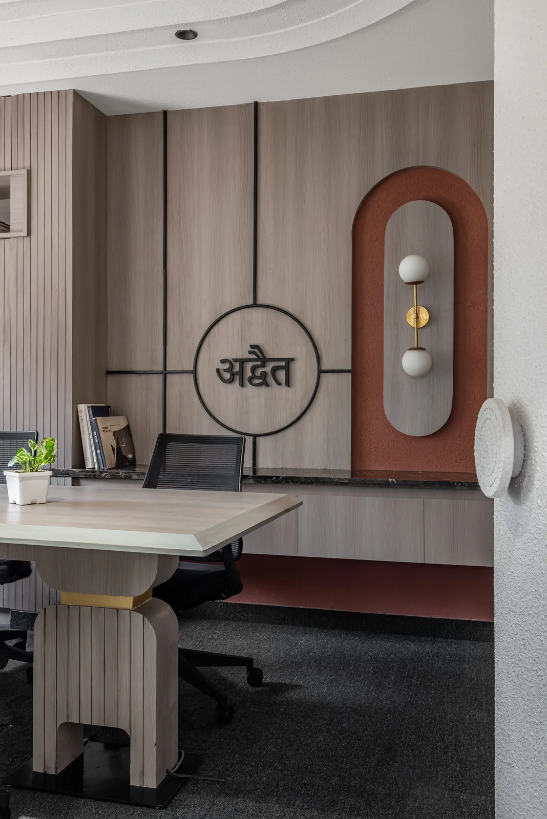 ADVAIT studio, lounge stone wall with brass lettering